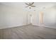 Bedroom with wood-look tile floors, ceiling fan, and open doorways to other rooms at 5701 Crestview Dr, Lady Lake, FL 32159