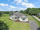 Well-maintained home featuring lush green lawn, stone accents, and a paved driveway at 5701 Crestview Dr, Lady Lake, FL 32159