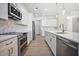 Well-lit kitchen with white cabinetry, quartz counters, and stainless steel appliances at 5701 Crestview Dr, Lady Lake, FL 32159