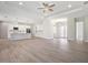 Spacious living room showcasing light wood flooring and a view into the kitchen and front entryway at 5701 Crestview Dr, Lady Lake, FL 32159