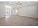 Large open living room with neutral paint and light-colored wood flooring at 5701 Crestview Dr, Lady Lake, FL 32159