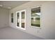 Covered patio showcasing double doors and a window overlooking the exterior of the home at 5701 Crestview Dr, Lady Lake, FL 32159