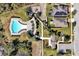 Aerial view of community pool, sidewalks, and nearby homes at 580 Seattle Slew Dr, Davenport, FL 33837