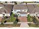 An aerial view of a well-maintained home featuring a brick driveway and landscaped yard at 580 Seattle Slew Dr, Davenport, FL 33837