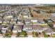 Aerial neighborhood view showcasing neatly lined homes with well-kept lawns along a highway at 580 Seattle Slew Dr, Davenport, FL 33837