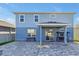 Expansive backyard with paved patio, covered area, and blue exterior at 580 Seattle Slew Dr, Davenport, FL 33837