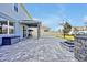 Large paver patio in backyard with covered area, fire pit, and basketball hoop at 580 Seattle Slew Dr, Davenport, FL 33837
