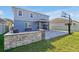 Spacious backyard with a stone patio, a swing, a basketball hoop, and well-maintained lawn at 580 Seattle Slew Dr, Davenport, FL 33837