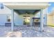 Covered patio with ceiling fan, paver flooring, and outdoor seating in backyard at 580 Seattle Slew Dr, Davenport, FL 33837