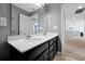 Bright bathroom featuring a double sink vanity with quartz countertops and sleek dark cabinets at 580 Seattle Slew Dr, Davenport, FL 33837