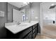 Bright bathroom features a double sink vanity with dark cabinetry and a large mirror, great for convenience at 580 Seattle Slew Dr, Davenport, FL 33837