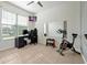 Bedroom/office combo with an exercise bike, desk, and a wall-mounted TV at 580 Seattle Slew Dr, Davenport, FL 33837