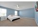 Comfortable bedroom features a ceiling fan, carpet, and natural light at 580 Seattle Slew Dr, Davenport, FL 33837