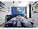 Comfortable bedroom featuring an accent wall, ceiling fan, and nature-themed decor at 580 Seattle Slew Dr, Davenport, FL 33837
