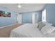 This bedroom offers soft, blue-painted walls and a large window for ample natural light at 580 Seattle Slew Dr, Davenport, FL 33837