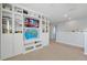 Bright bonus room features a large built-in shelving unit and plenty of space for entertaining or relaxing at 580 Seattle Slew Dr, Davenport, FL 33837