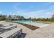 Outdoor community pool area features stylish lounge chairs and neatly landscaped surroundings at 580 Seattle Slew Dr, Davenport, FL 33837