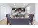 Dining area showing a glass table and chairs adjacent to the kitchen at 580 Seattle Slew Dr, Davenport, FL 33837