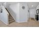 Inviting entryway featuring a staircase, neutral wall color and tiled floor at 580 Seattle Slew Dr, Davenport, FL 33837