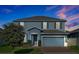 Charming two-story home with a two-car garage and well-manicured lawn at 580 Seattle Slew Dr, Davenport, FL 33837
