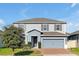 Inviting two-story home featuring a well-kept lawn and neutral color scheme at 580 Seattle Slew Dr, Davenport, FL 33837