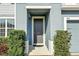 Welcoming front entrance with a covered porch and manicured shrubbery at 580 Seattle Slew Dr, Davenport, FL 33837