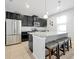 Modern kitchen with a large island, granite countertops, and stainless steel appliances at 580 Seattle Slew Dr, Davenport, FL 33837