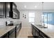 An airy kitchen equipped with granite counters, stainless appliances and dark cabinetry at 580 Seattle Slew Dr, Davenport, FL 33837