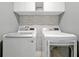 Functional laundry room with a washer and dryer, featuring modern appliances and a clean design at 580 Seattle Slew Dr, Davenport, FL 33837