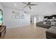 Open-concept living room with tile floors and a view of the kitchen at 580 Seattle Slew Dr, Davenport, FL 33837