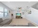 Open-concept living room with a large window and stylish decor accents at 580 Seattle Slew Dr, Davenport, FL 33837