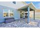 A covered patio with stylish pavers offers an inviting outdoor living space with a ceiling fan and backyard access at 580 Seattle Slew Dr, Davenport, FL 33837