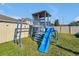 Backyard playground featuring a blue slide, stairs, monkey bars, and small upper story at 580 Seattle Slew Dr, Davenport, FL 33837