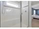 Glass shower features a built-in bench and a hand-held shower head and decorative tile accents at 580 Seattle Slew Dr, Davenport, FL 33837