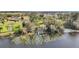 Aerial view showcasing a lakefront property with a private dock and lush green landscape at 6845 Old Melbourne Hwy, St Cloud, FL 34771