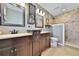 This primary bathroom offers dual sinks with stone countertops and a tiled walk-in shower at 6845 Old Melbourne Hwy, St Cloud, FL 34771