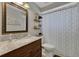 A clean bathroom with a single sink, marble counter, and patterned shower curtain at 6845 Old Melbourne Hwy, St Cloud, FL 34771