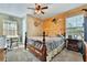 Bedroom with a wooden-slatted accent wall, a four-poster bed, and natural light at 6845 Old Melbourne Hwy, St Cloud, FL 34771