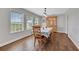 Dining room with hardwood floors and a table set for six, in a room with large windows at 6845 Old Melbourne Hwy, St Cloud, FL 34771