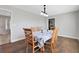 Dining room with hardwood floors and a table set for six, bathed in natural light at 6845 Old Melbourne Hwy, St Cloud, FL 34771