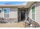 Cozy front porch features stone accents, comfortable seating, and a welcoming front door at 6845 Old Melbourne Hwy, St Cloud, FL 34771