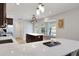Bright kitchen with stainless steel appliances, countertops, kitchen island, and a table by a window at 6845 Old Melbourne Hwy, St Cloud, FL 34771