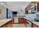 Modern kitchen with dark wood cabinets, stainless steel appliances, and an open layout at 6845 Old Melbourne Hwy, St Cloud, FL 34771
