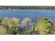 Scenic lake view featuring a private dock surrounded by trees and calm waters, offering a tranquil retreat at 6845 Old Melbourne Hwy, St Cloud, FL 34771