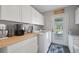 Laundry room featuring modern appliances, butcher block countertops, and natural light at 6845 Old Melbourne Hwy, St Cloud, FL 34771