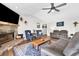 Spacious living room with a stone fireplace, wood floors, and comfortable seating arrangement at 6845 Old Melbourne Hwy, St Cloud, FL 34771