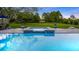 Sparkling swimming pool with an attached hot tub and a spacious green lawn beyond at 6845 Old Melbourne Hwy, St Cloud, FL 34771