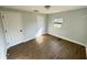 Bedroom featuring wood flooring, closet, door, and window at 708 Se Pine Ave, Fort Meade, FL 33841