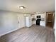 Open-concept kitchen with white appliances, cabinets, and modern vinyl flooring throughout the home at 708 Se Pine Ave, Fort Meade, FL 33841