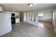 Open floor plan with kitchen and living room featuring modern vinyl flooring at 708 Se Pine Ave, Fort Meade, FL 33841